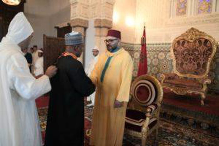 Nigeria’s Ambassador to Morocco, Mr. Baba Garba (m) being congratulated by King Mohammed VI, after conferment with Wissam Al Alaoui at the Royal Palace in Rabat, Morocco on Sunday. [NAN]