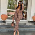 Kiki Osinbanjo wearing a tartan pant suit [Instagram: kikiosinbanjo]