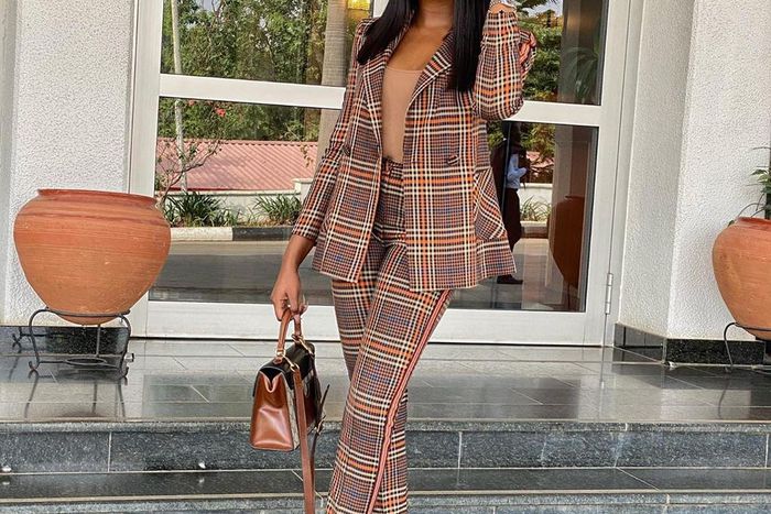 Kiki Osinbanjo wearing a tartan pant suit [Instagram: kikiosinbanjo]