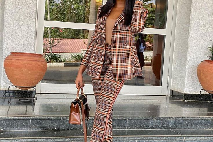 Kiki Osinbanjo wearing a tartan pant suit [Instagram: kikiosinbanjo]