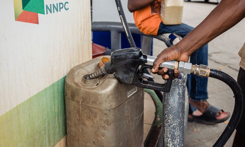 A fuel attendant fills a container with fuel for a customer at a Nigerian National Petroleum Company Ltd. (NNPC) gas station in Lagos, Nigeria, on Wednesday, Aug. 23, 2023. [Getty Images]
