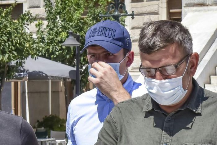 Harry Maguire (L) leaves a courthouse on the Greek island of Syros on Saturday