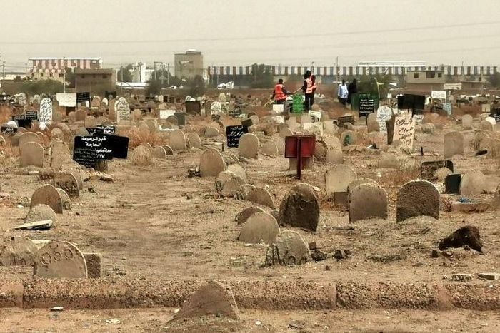 A picture taken on June 13, 2020, shows members of a forensic team at a cemetery where a mass grave of conscripts killed in 1998 was discovered, in the Sahafa neighbourhood, south of the Sudanese capital Khartoum