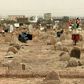 A picture taken on June 13, 2020, shows members of a forensic team at a cemetery where a mass grave of conscripts killed in 1998 was discovered, in the Sahafa neighbourhood, south of the Sudanese capital Khartoum