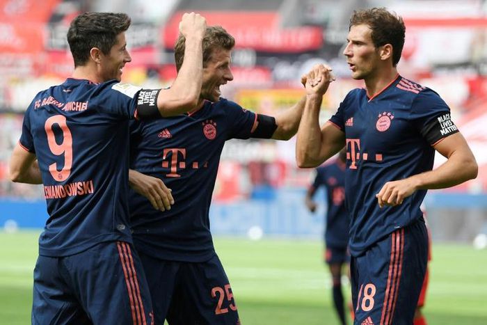 Midfielder Leon Goretzka celebrates with Bayern Munich team-mates Robert Lewandowski (L) and Thomas Mueller in the 4-2 win at Bayer Leverkusen