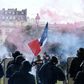 Tear gas hovers at the Les Invalides complex in central Paris during the protest