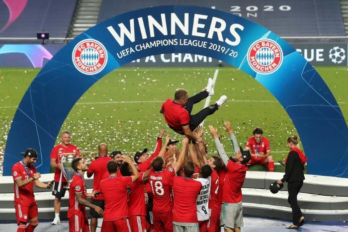 The Bayern Munich squad throw head coach Hansi Flick in the air after winning the Champions League final.
