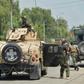 Afghan soldiers arrive during an attack on a prison in Jalalabad. At least 29 people have been killed in fighting at the jail, which houses 1,700 Islamic State and Taliban inmates