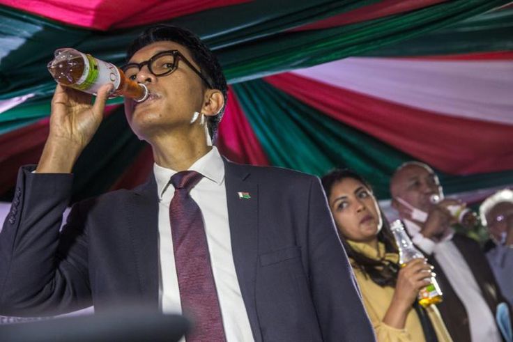 Madagascar's President Andry Rajoelina drinks a sample of Covid-Organics, the herbal tea he is promoting as a cure for coronavirus