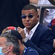 A dapper Kylian Mbappe watches Friday's French League Cup final from the stand -- the striker missed PSG's clash with Lyon because of an ankle injury