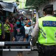 Alongside police and troops overseeing enforcement measures, provincial leaders are running their own zealous campaigns to fight the virus in Indonesia