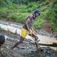 A group mines gold from a riverbed southwest of the city of Bukavu, in the DR Congo in March 2017