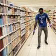 A man disinfects an empty supermarket in Dakar