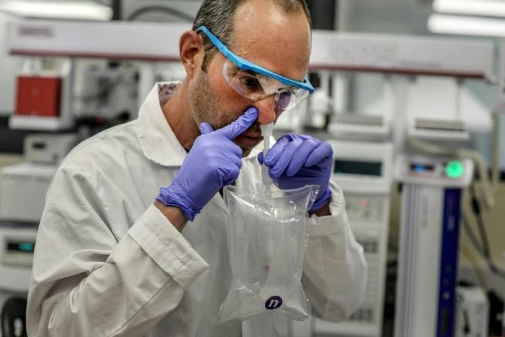 A researcher demonstrates a coronavirus breathalyser test at NanoScent's lab in Israel