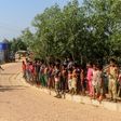 Security personnel use a loudspeaker to raise awareness about the coronavirus in a Rohingya refugee camp in southeast Bangladesh