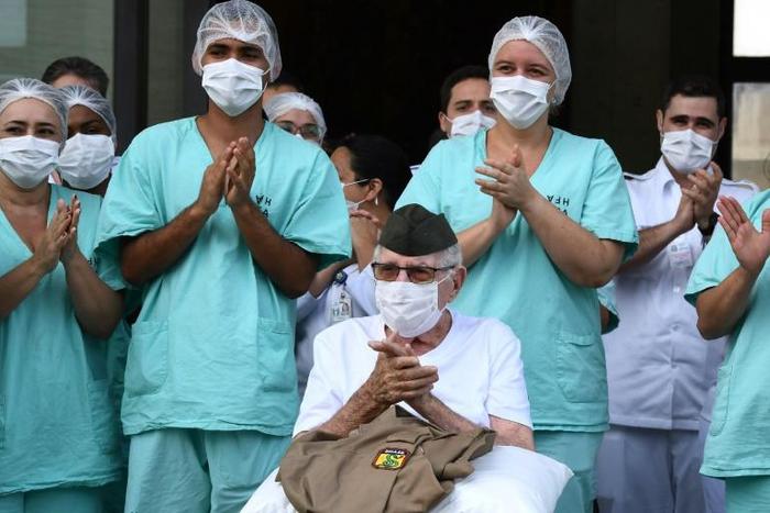Second Lieutenant Ermando Piveta, who served in the Brazilian artillery in Africa during World War II, was brought out of the Armed Forces Hospital in Brasilia to a burst of trumpet music and applause after recovering from the new coronavirus
