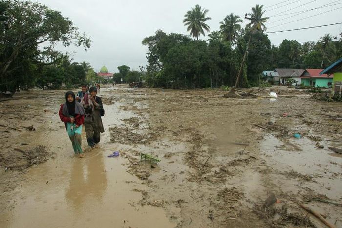 More than 14,000 people on the island of Sulawesi have been left homeless after flash floods engulfed thousands of houses in mud