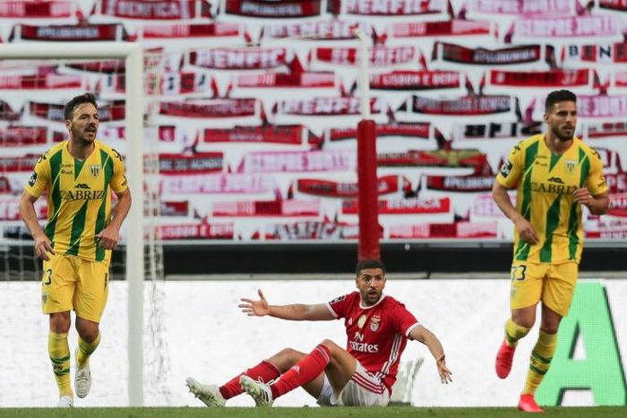 Is there anybody there? Benfica's Moroccan midfielder Adel Taarabt protests during the Portuguese league match against CD Tondela in front of a wall of scarves in the absence of spectators