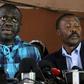 Opposition leader Kizza Besigye, left, speaking to the press after being bailed on treason charges in July 2016