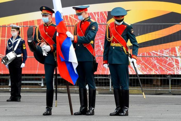 Donning face masks and gloves, Russian servicemen take part in a rehearsal for Wednesday's parade