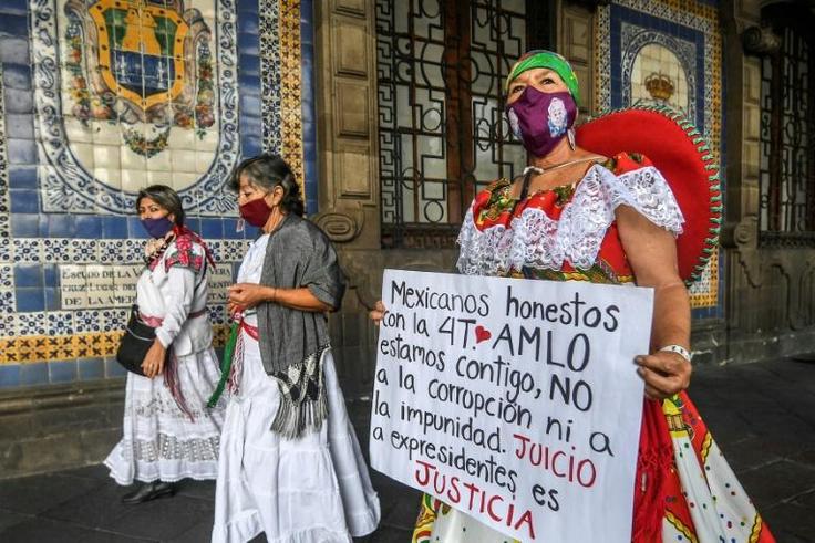 Supporters of Mexican President Andres Manuel Lopez Obrador hold a protest to call for his predecessors to face trial over corruption allegations