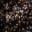 Hong Kongers hold up their mobile phones during a rally in Causeway Bay on June 12 to mark the one-year anniversary of the start of major pro-democracy protests in the city
