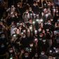 Hong Kongers hold up their mobile phones during a rally in Causeway Bay on June 12 to mark the one-year anniversary of the start of major pro-democracy protests in the city