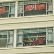Fans cheer from a hotel beside the stadium during the Chinese Super League (CSL) football match between Shanghai SIPG and Tianjin Teda in Suzhou