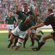 Springbok Kobus Wiese (C) loses the ball as he falls between All Blacks Jonah Lomu (behind) and Robin Brooke (R) during the 1995 Rugby World Cup final  in Johannesburg