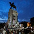 Protestors surround the statue of Confederate general Robert E. Lee in Richmod which the Virginia governor announced would be removed 'as soon as possible'