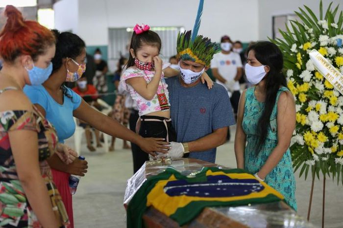 Indigenous from the Parque das Tribos community mourn besides the coffin of Chief Messias, 53, of the Kokama tribe who died victim of the new coronavirus, COVID-19, in Manaus, Brazil, on May 14, 2020