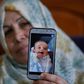 The grandmother of Palestinian baby Omar Yagi displays a picture of him taken before his death in Gaza last week from a serious heart condition he had been due to receive life-saving surgery in Israel for