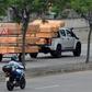 Coffins are seen stacked high on a pick-up truck and trailer as it passes a hospital in Guayaquil, Ecuador
