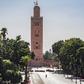 A few people walk by next to the Kutubiyya mosque's minaret tower at the Jemaa el-Fna square in the Moroccan city of Marrakesh on September 8, 2020, currently empty of its usual crowds due to the COVID-19 pandemic