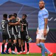 Lyon players celebrate after Moussa Dembele's second goal which sealed their 3-1 win over Manchester City in the Champions League quarter-finals in Lisbon on Saturday