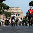 People exercise along Via dei Fori Imperiali in central Rome as Italy begins the careful process of easing its virus lockdown