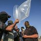 Palestinian militants attach a fire bomb to inflated plastic bags and condoms before launching it across the Gaza border into Israel