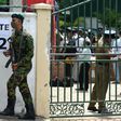 A Sri Lanka Special Task Force soldier stands guard as electoral officials collect ballot papers and boxes from a distribution centre in Colombo