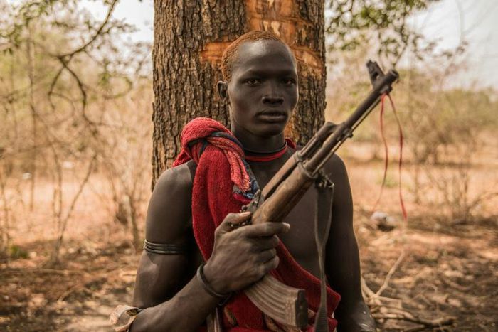 A young herdsman from the Dinka tribe poses with a semi-automatic weapon. Guns are rife in rural South Sudan, for self-protection or defence against cattle raiders