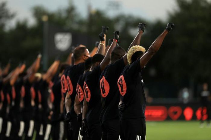 MLS players hold a silent Black Lives Matter ceremony before the league's restart tournament in Orlando