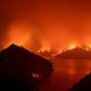 Flames surround Lake Berryessa during the LNU Lightning Complex fire in Napa, California on August 19, 2020