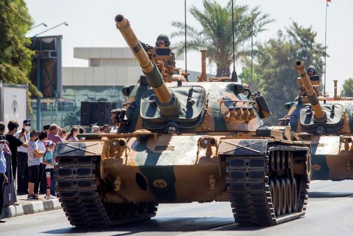 Turkish troops parade atop armoured vehicles in the northern part of Nicosia, the capital of the self-proclaimed Turkish Republic of Northern Cyprus on July 20, 2020, to mark the 46th anniversary of the Turkish invasion in 1974.