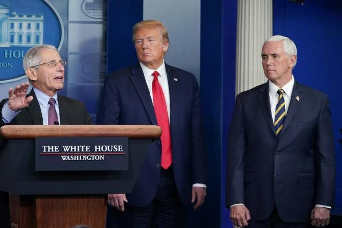 Director of the National Institute of Allergy and Infectious Diseases Anthony Fauci, flanked by US President Donald Trump and US Vice President Mike Pence, speaks during a task force briefing in late April