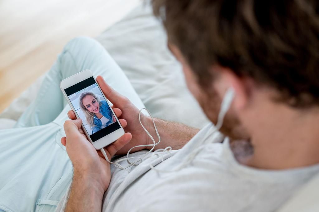 Man video chatting on his cell phone