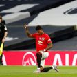 Manchester United striker Marcus Rashford (right) takes a knee before kick-off against Tottenham