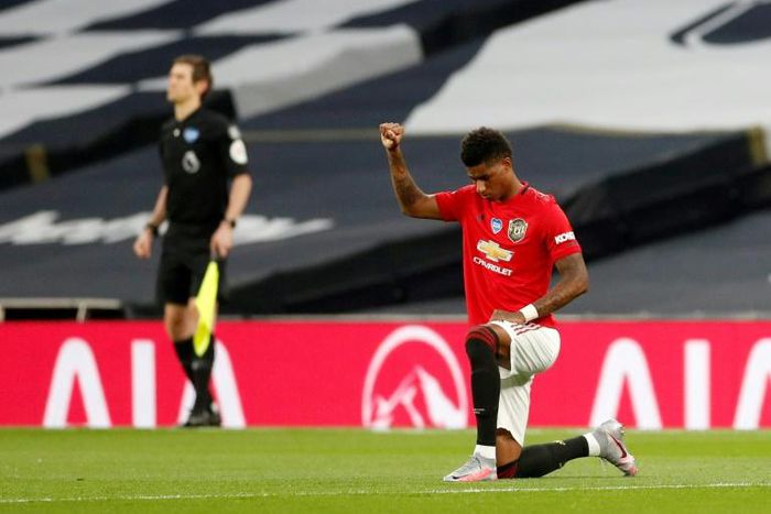 Manchester United striker Marcus Rashford (right) takes a knee before kick-off against Tottenham