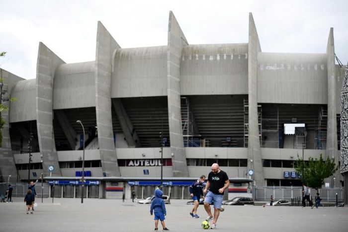 A child playing football outside Paris Saint-Germain's Parc des Princes. PSG were 12 points clear at the top of Ligue 1 when the French season was suspended