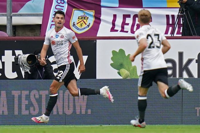 Sheffield United defender John Egan (L) celebrates after equalising at Burnley
