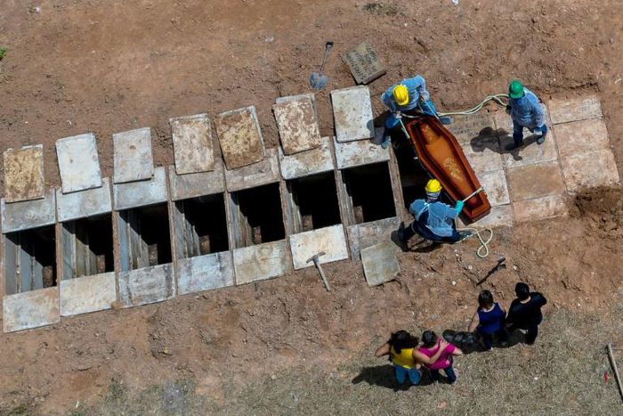 An aerial view of a burial is seen at the Bom Jardim cemetery, the largest public cemetery in Fortaleza, Ceara state, Brazil on May 7, 2020, as many of the burials were of people who were confirmed or suspected to have died from COVID-19