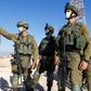 Israeli soldiers monitor the country's border with Lebanon near the northern town of Metula on July 14